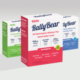 Three boxes of RallyBear electrolyte sticks arranged on a light gray studio background. The center box is prominent and labeled Watermelon, with red lower half, blue branding, and white top.
